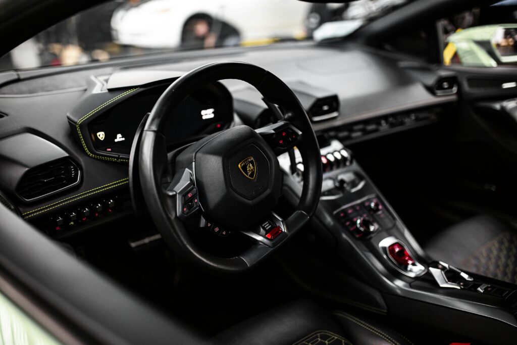 pexels photo 4984313 4984313 Close-up view of a luxurious Lamborghini car interior, showcasing the modern steering wheel and dashboard design.